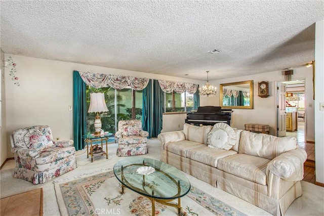 living room featuring carpet flooring, a textured ceiling, and a chandelier