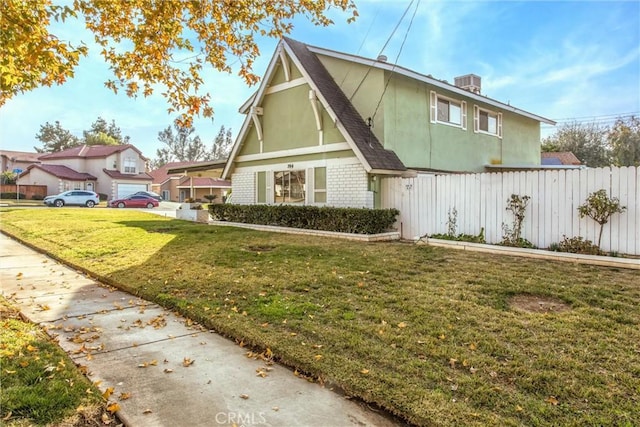 exterior space with central AC unit and a lawn