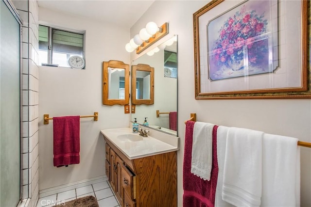 bathroom featuring vanity, a shower with shower door, and tile patterned flooring