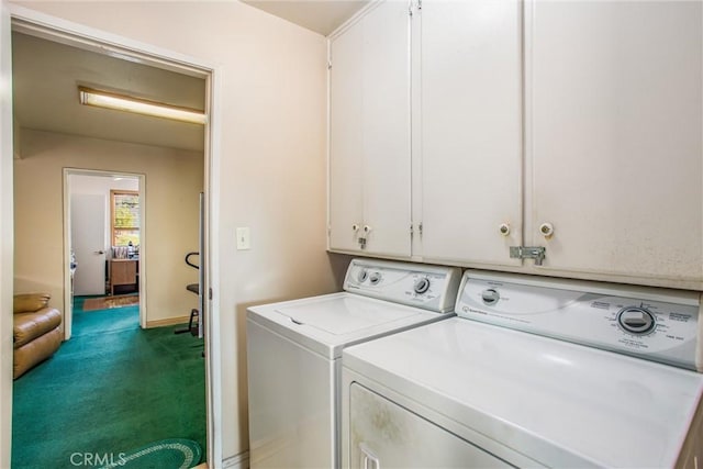 washroom with cabinets, carpet floors, and washer and clothes dryer