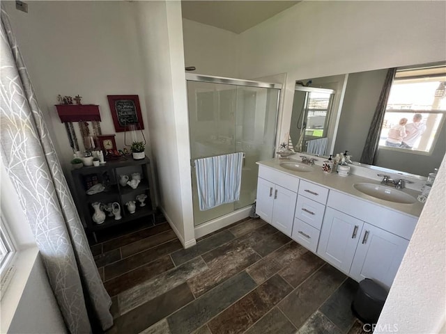 bathroom featuring vanity, wood-type flooring, and walk in shower