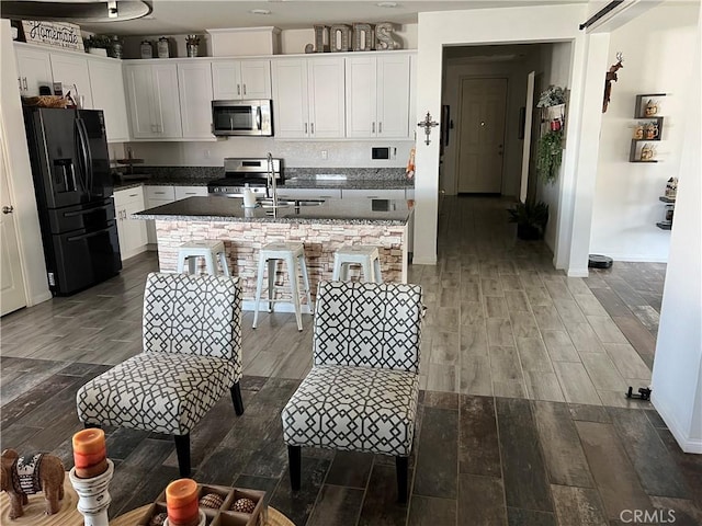 kitchen featuring white cabinetry, sink, and appliances with stainless steel finishes