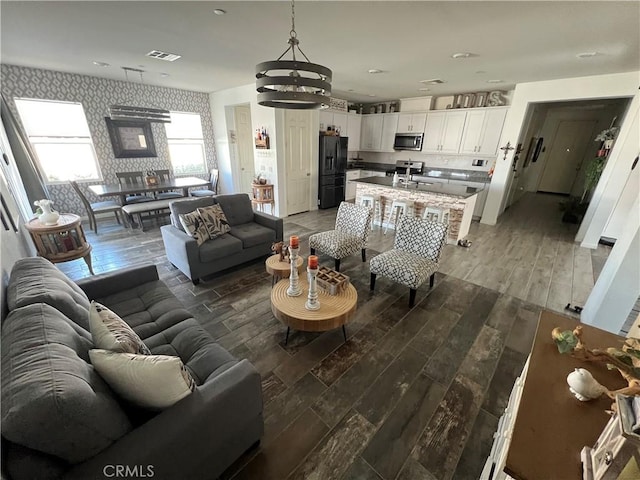 living room with sink and wood-type flooring