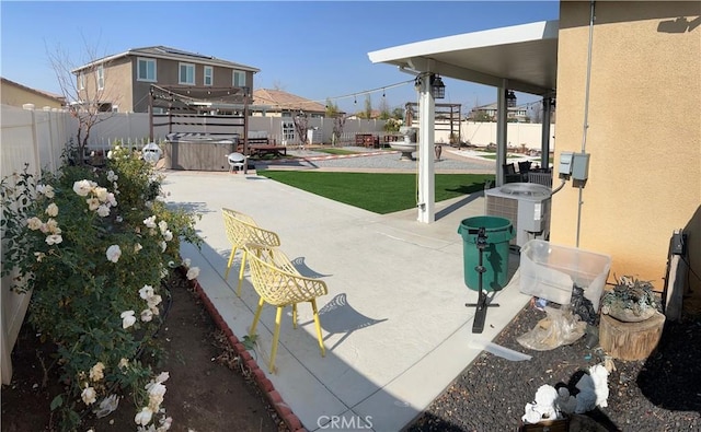 view of patio / terrace featuring a hot tub and central AC unit