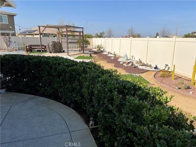 view of yard with a pergola and a patio