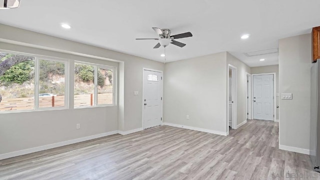 empty room with light hardwood / wood-style floors and ceiling fan