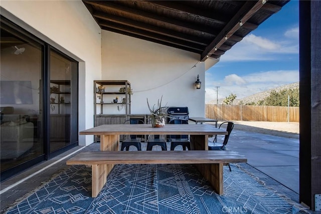 view of patio / terrace with a mountain view and a grill