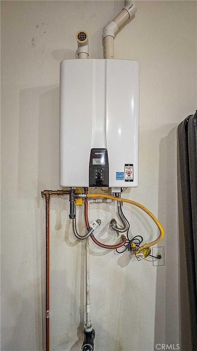 utility room featuring water heater