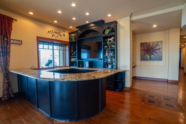 kitchen with light stone counters, dark hardwood / wood-style flooring, crown molding, and kitchen peninsula