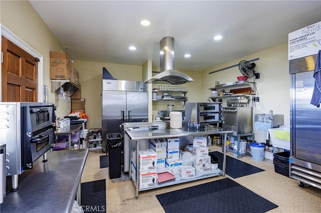 kitchen with island range hood, stainless steel counters, and stainless steel built in refrigerator