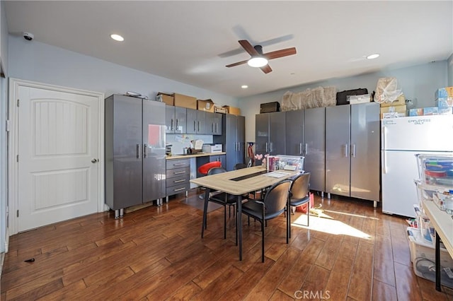 kitchen with white refrigerator, dark hardwood / wood-style floors, gray cabinetry, and ceiling fan