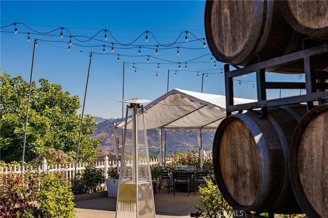 view of property's community with a mountain view and a patio area