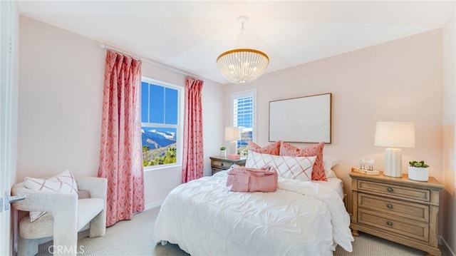 carpeted bedroom with a chandelier