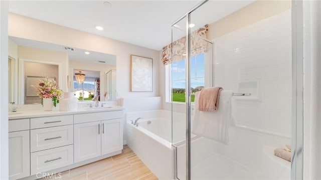 bathroom featuring vanity and separate shower and tub