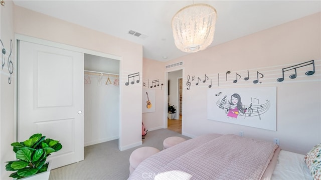 bedroom featuring light colored carpet, a chandelier, and a closet