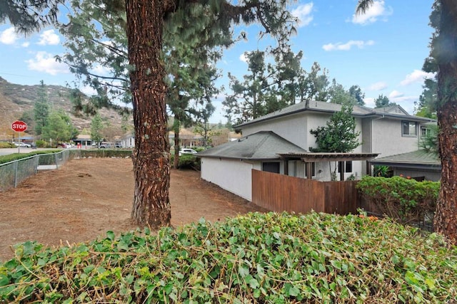 view of property exterior with a mountain view