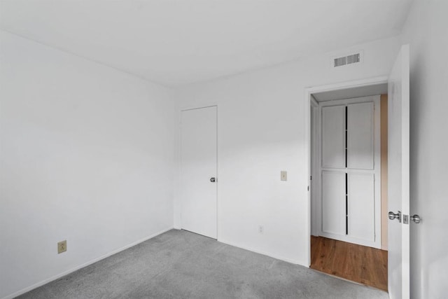 unfurnished room featuring light colored carpet