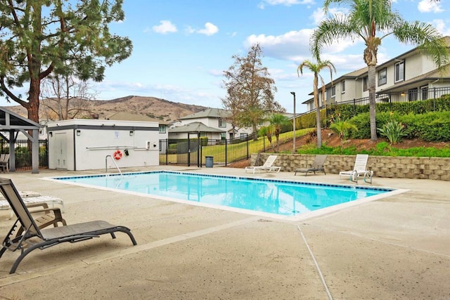 view of pool with a mountain view and a patio area