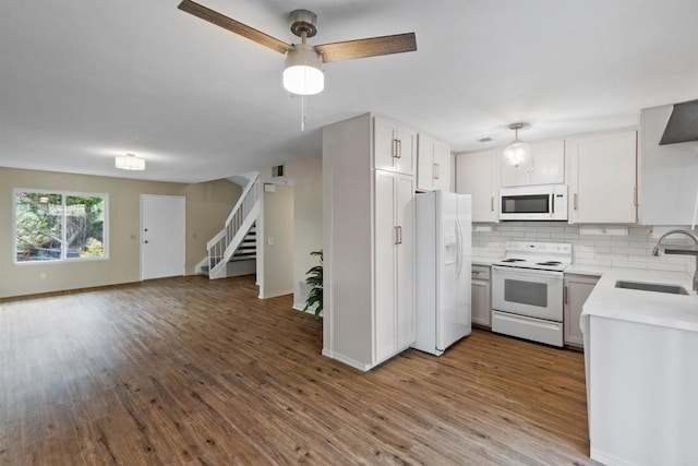 kitchen with sink, white cabinets, decorative backsplash, white appliances, and light hardwood / wood-style flooring