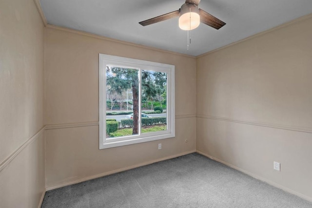 empty room with carpet floors, ornamental molding, and ceiling fan