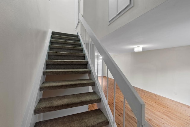 staircase featuring hardwood / wood-style flooring