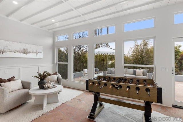 sunroom featuring beamed ceiling