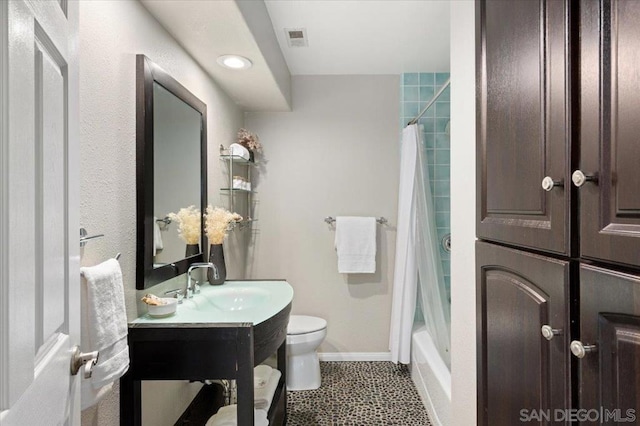 full bathroom featuring shower / bath combination with curtain, tile patterned floors, vanity, and toilet