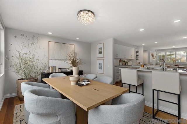 dining room featuring sink and light wood-type flooring