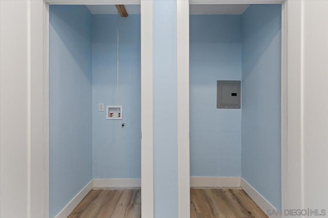 washroom with washer hookup, electric panel, and light hardwood / wood-style floors