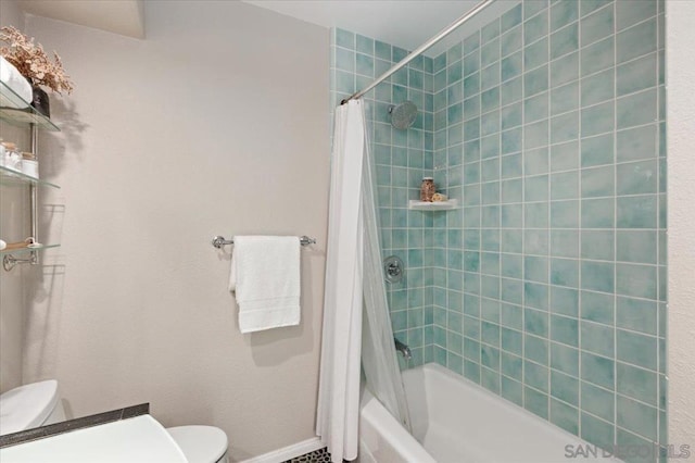 bathroom with shower / bath combo with shower curtain and toilet