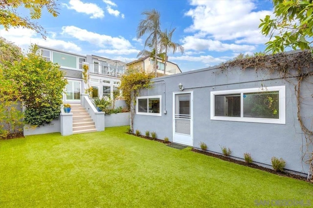 rear view of house with a yard