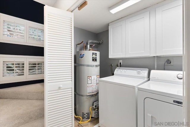 laundry area featuring secured water heater, cabinets, and independent washer and dryer