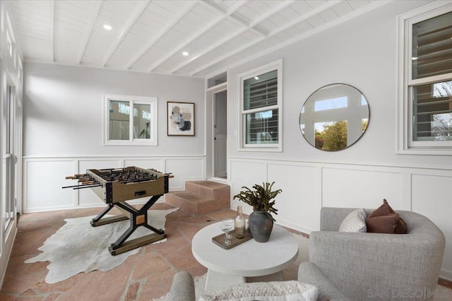 sitting room with beam ceiling and wooden ceiling