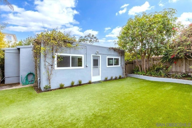 rear view of house with a yard