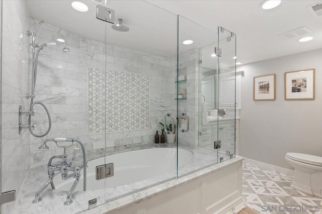 bathroom featuring bath / shower combo with glass door and toilet