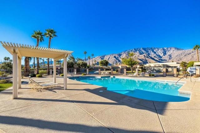 view of pool featuring a patio, a mountain view, and a pergola