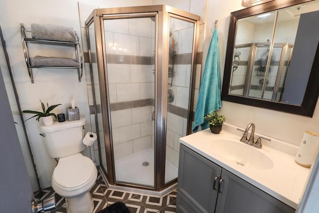 bathroom featuring vanity, walk in shower, and toilet