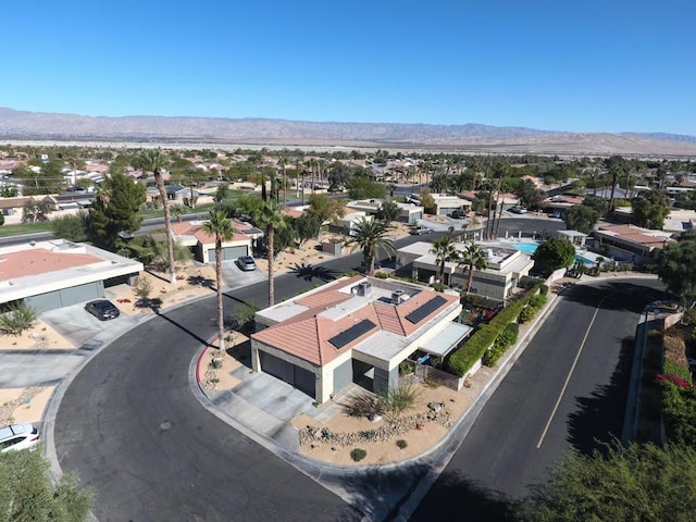 birds eye view of property with a mountain view