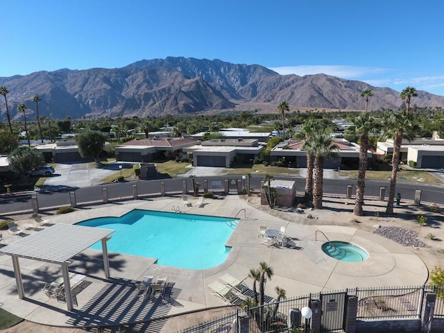 view of swimming pool featuring a community hot tub, a pergola, a mountain view, and a patio area