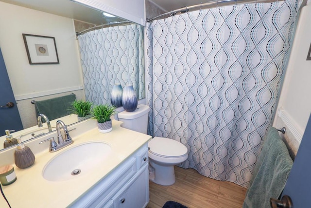 bathroom featuring vanity, hardwood / wood-style floors, and toilet