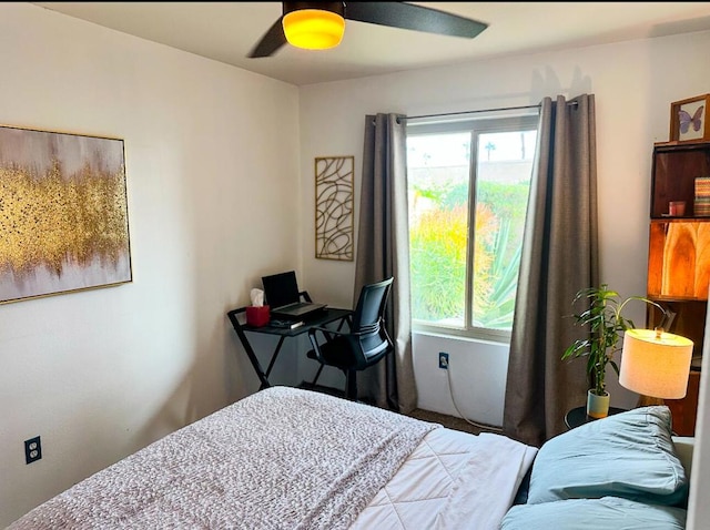 bedroom with ceiling fan and multiple windows