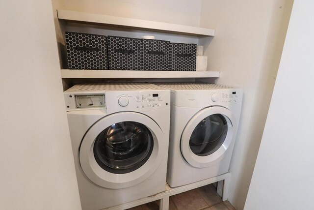 washroom with washing machine and dryer and tile patterned floors