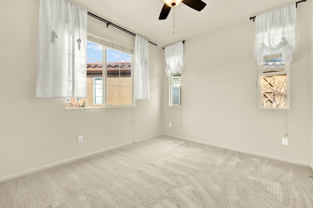 carpeted empty room featuring ceiling fan