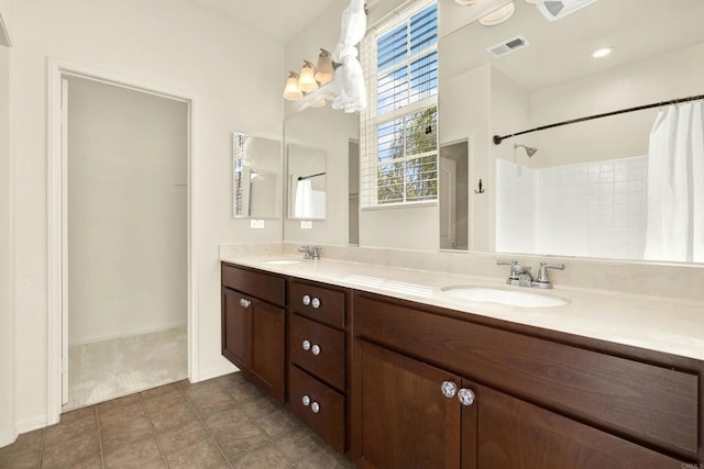 bathroom featuring vanity, tile patterned floors, and walk in shower