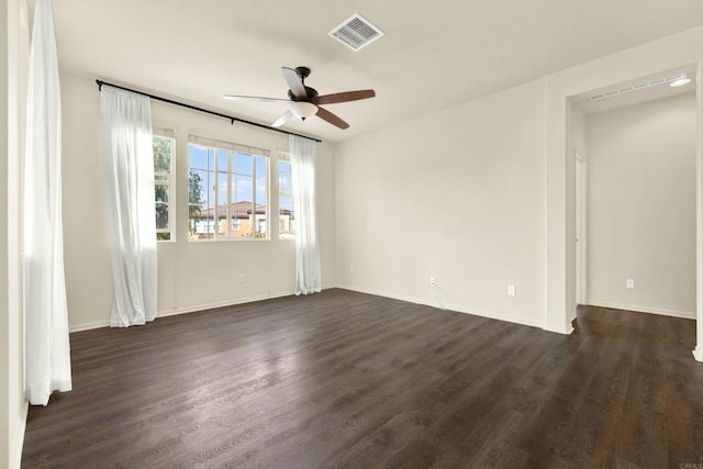 empty room featuring ceiling fan and dark hardwood / wood-style floors