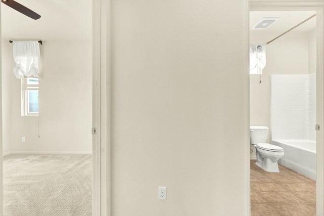 bathroom with ceiling fan, toilet, and bathing tub / shower combination