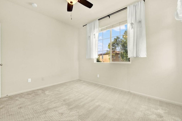 unfurnished room featuring ceiling fan and light colored carpet