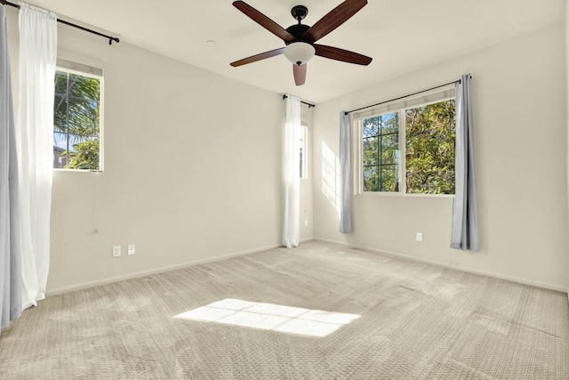 carpeted empty room with plenty of natural light and ceiling fan