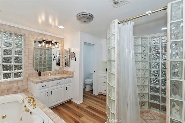 full bathroom with ornamental molding, vanity, toilet, and wood-type flooring