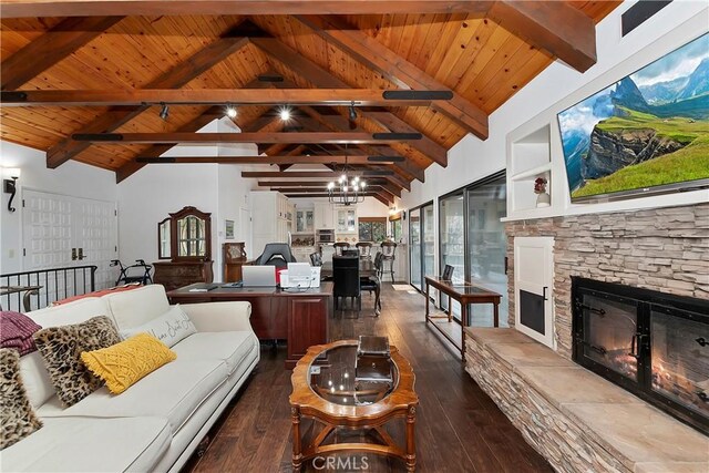 living room with wood ceiling, dark hardwood / wood-style floors, a stone fireplace, and vaulted ceiling with beams